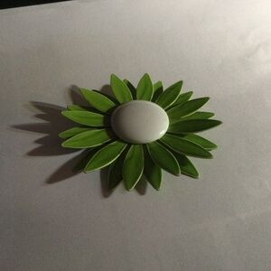 Retro green and white enamel pin.